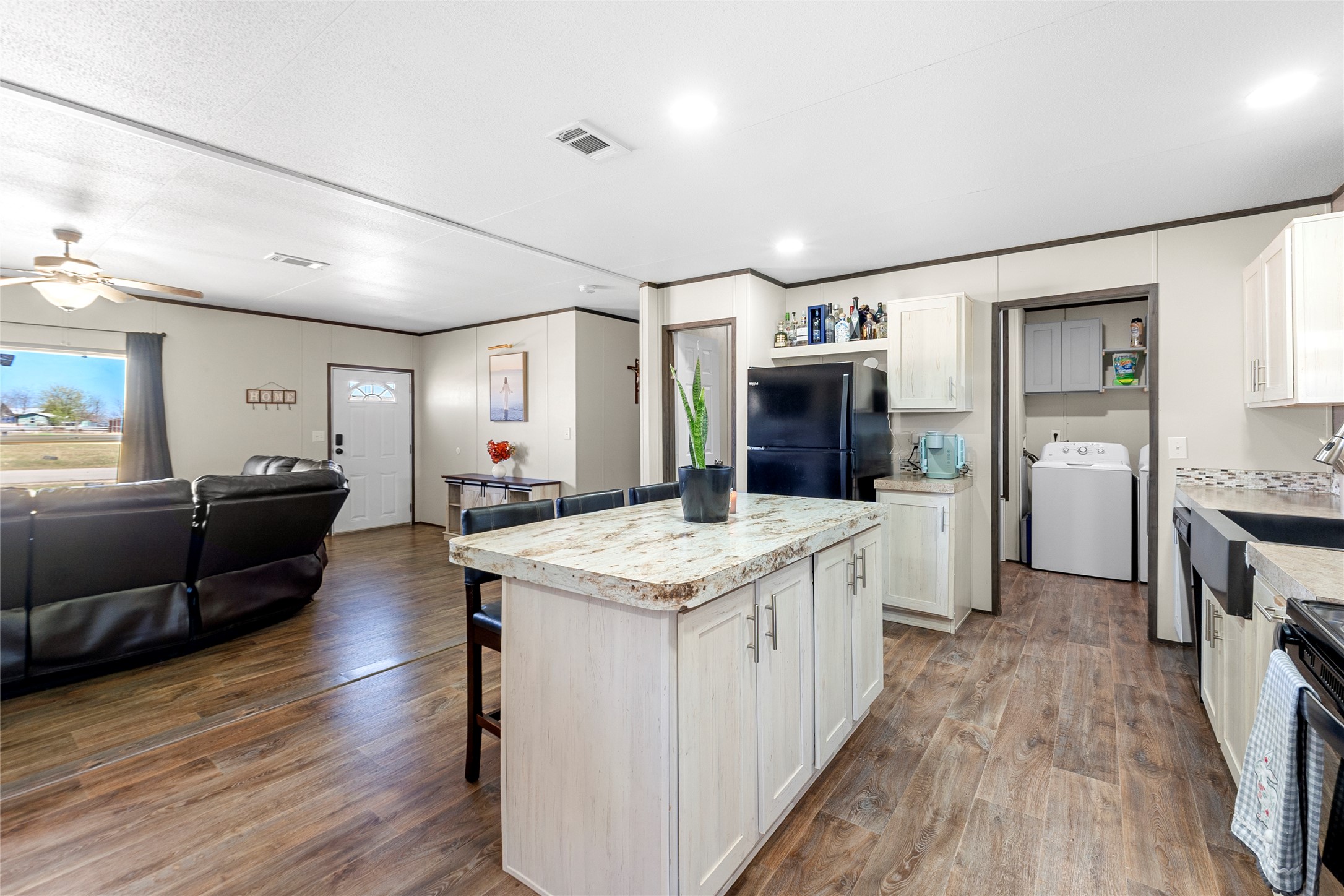 22774 Windy Mdws Cove Jarrell, TX 76537 - Photo 29 of 30 a kitchen with stainless steel appliances kitchen island granite countertop a stove and a sink