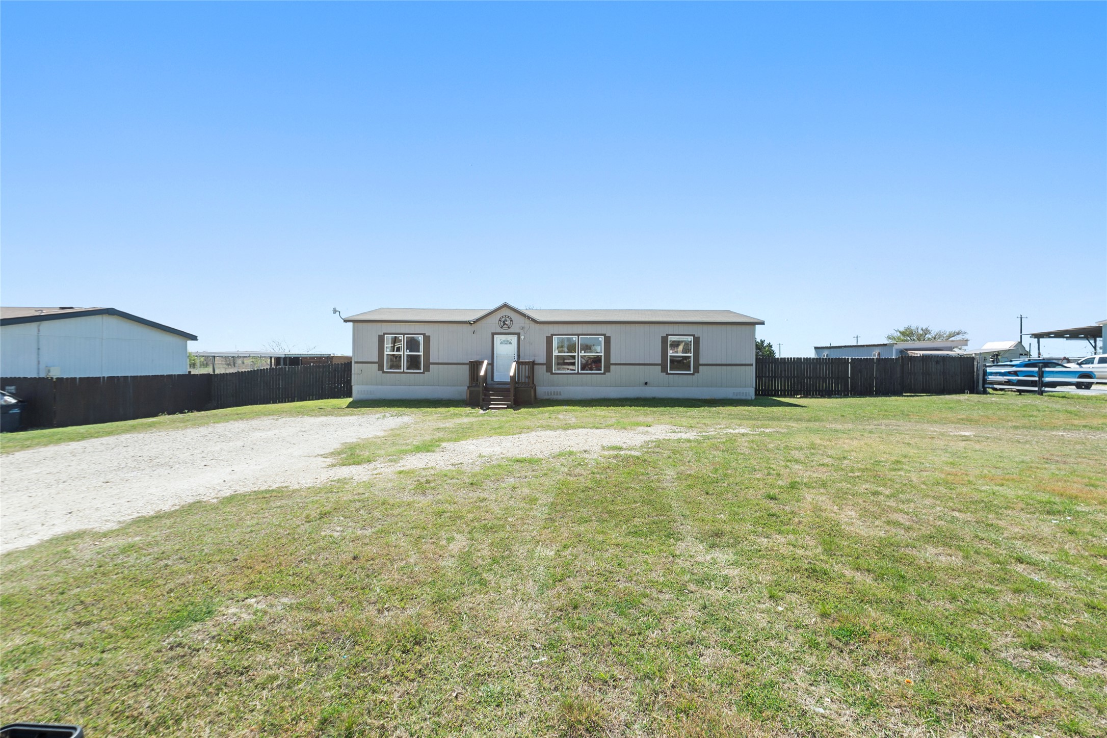 22774 Windy Mdws Cove Jarrell, TX 76537 - Photo 2 of 30 a front view of a house with a garden
