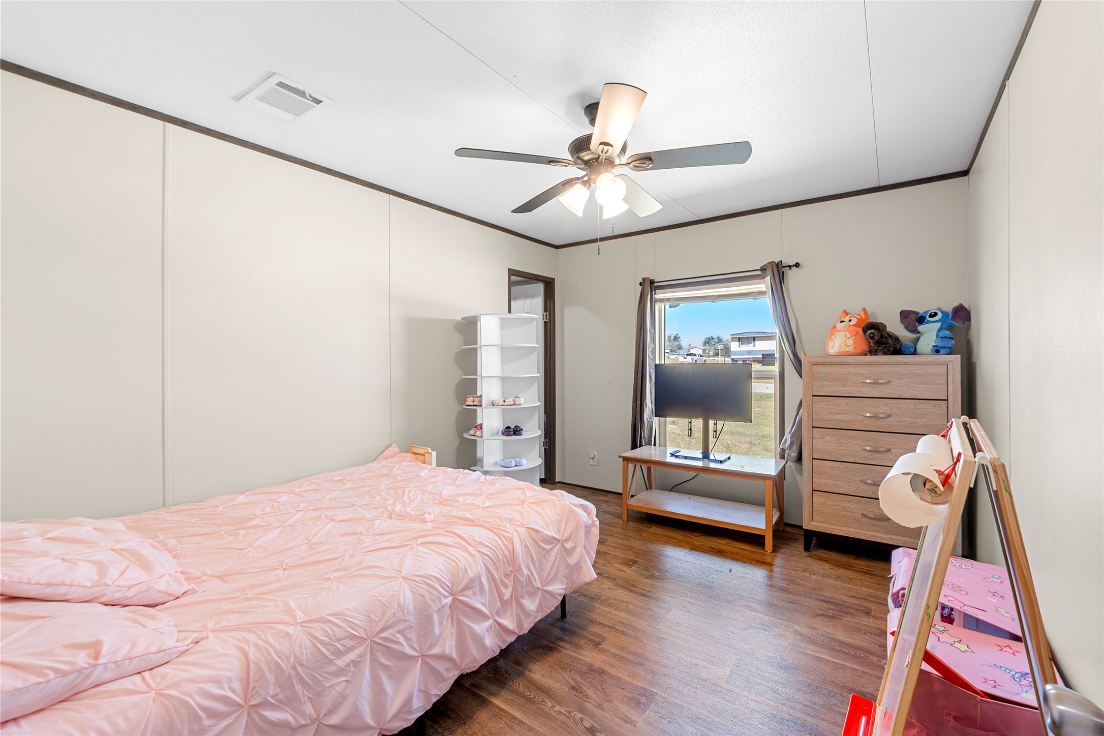 22774 Windy Mdws Cove Jarrell, TX 76537 - Photo 20 of 30 a bedroom with a bed and a chandelier