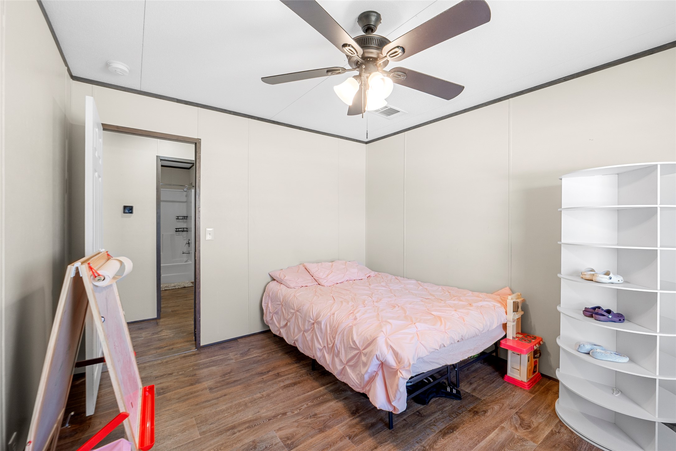 22774 Windy Mdws Cove Jarrell, TX 76537 - Photo 21 of 30 a bedroom with a bed and a chandelier