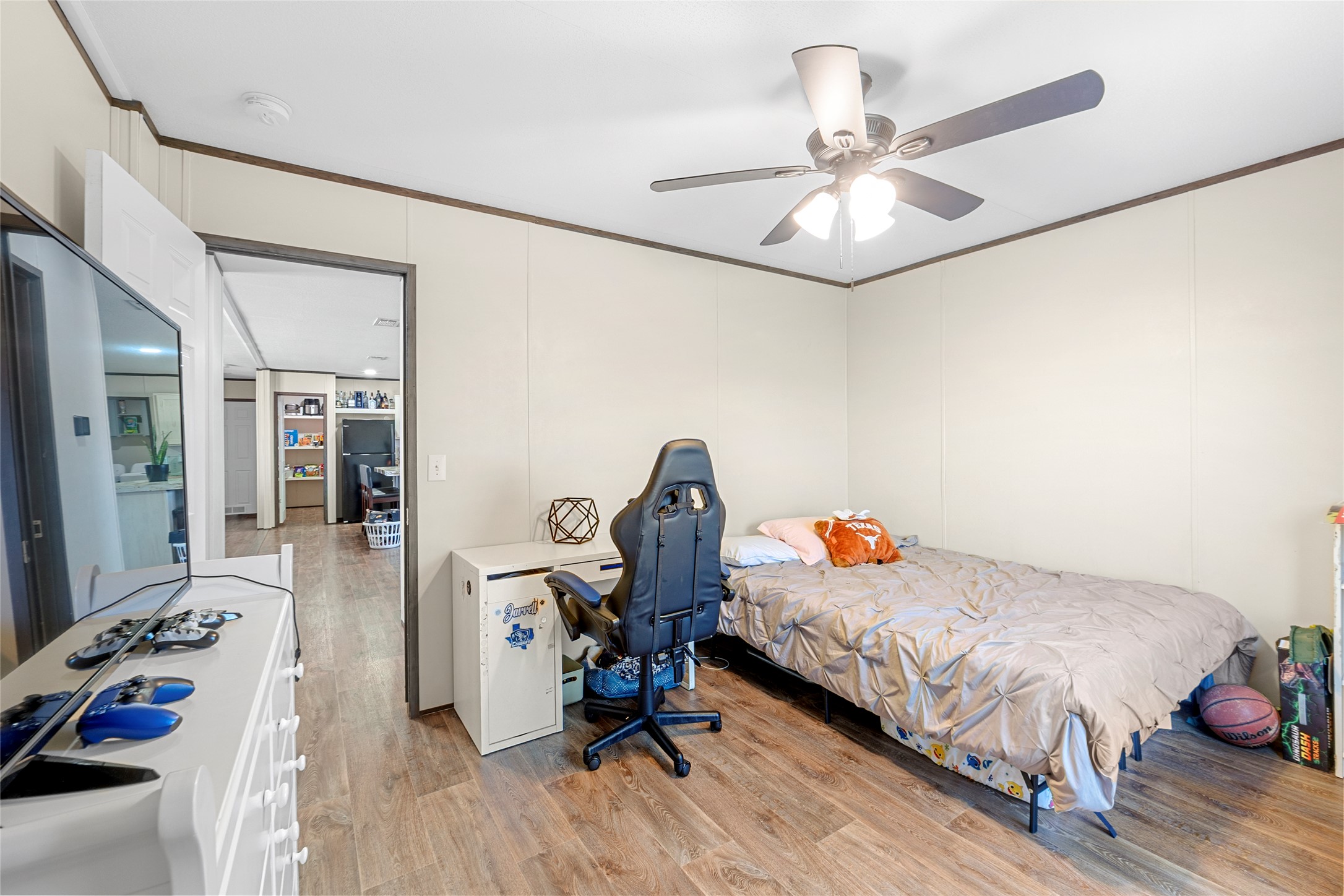 22774 Windy Mdws Cove Jarrell, TX 76537 - Photo 23 of 30 a bedroom with a bed and wooden floor