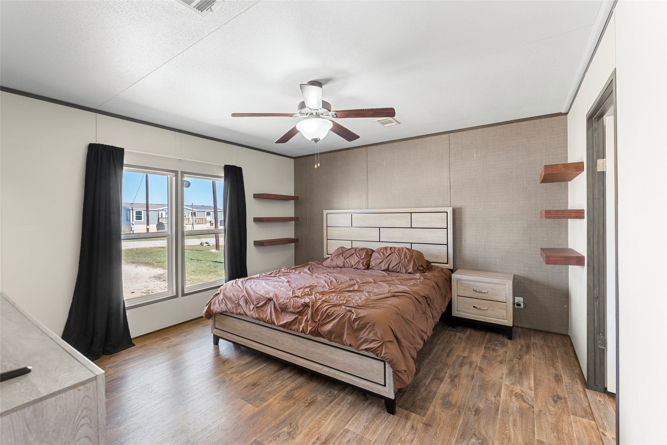 22774 Windy Mdws Cove Jarrell, TX 76537 - Photo 5 of 30 a bedroom with a bed and a large window with the outer view