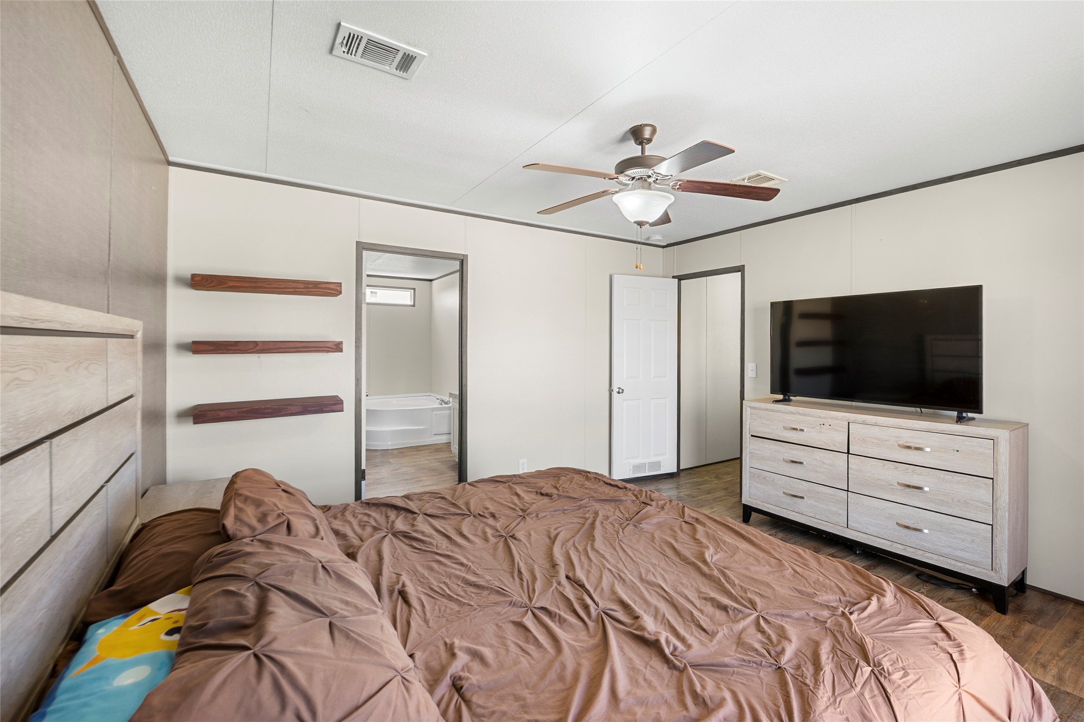 22774 Windy Mdws Cove Jarrell, TX 76537 - Photo 6 of 30 a bedroom with a bed and a flat screen tv