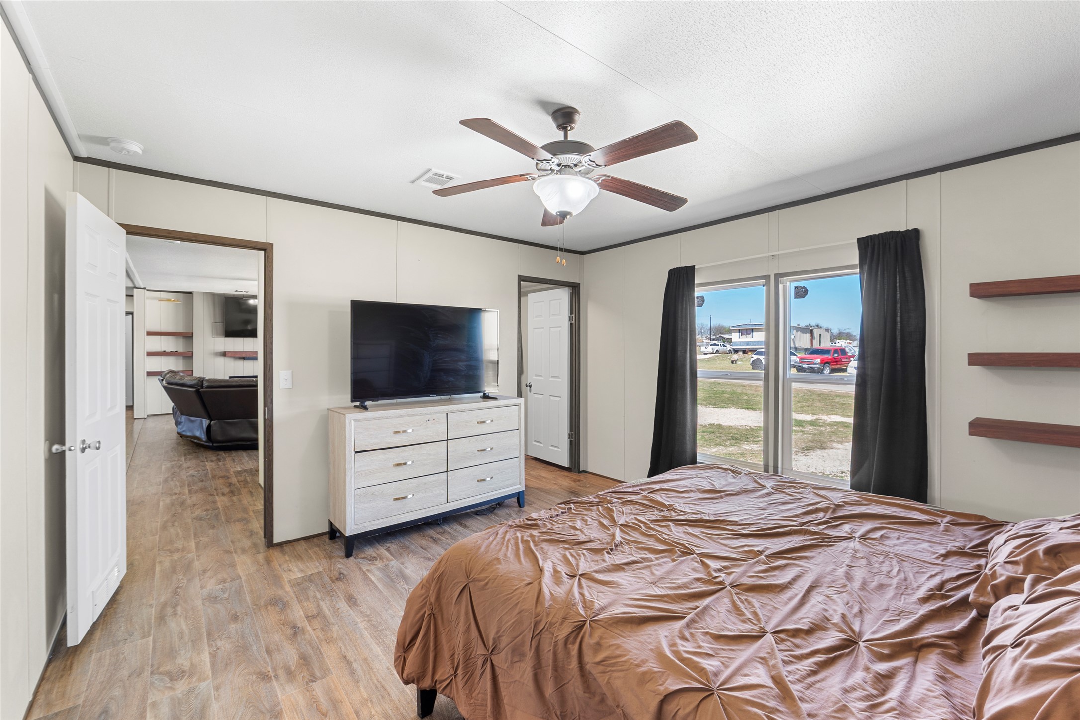 22774 Windy Mdws Cove Jarrell, TX 76537 - Photo 7 of 30 a bedroom with a bed and a flat screen tv