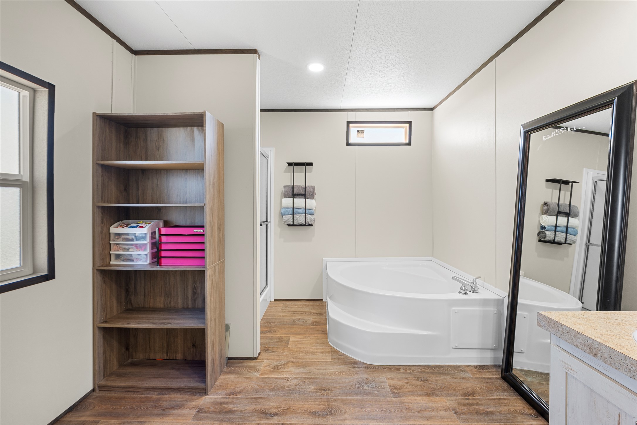 22774 Windy Mdws Cove Jarrell, TX 76537 - Photo 9 of 30 a white bath tub sitting next to a white sink and vanity