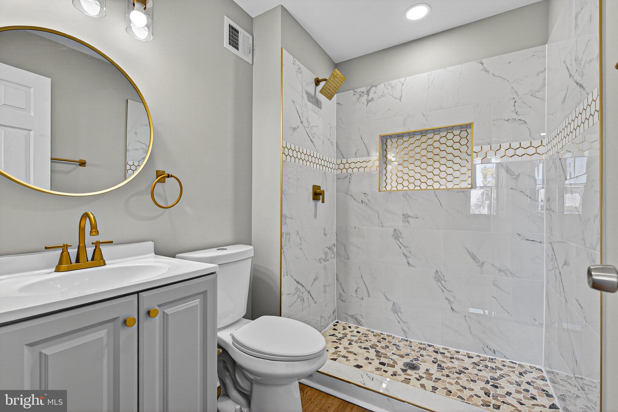 2001 North Fulton Avenue Baltimore, MD 21217 - Photo 17 of 28 a bathroom with a sink a toilet and a mirror