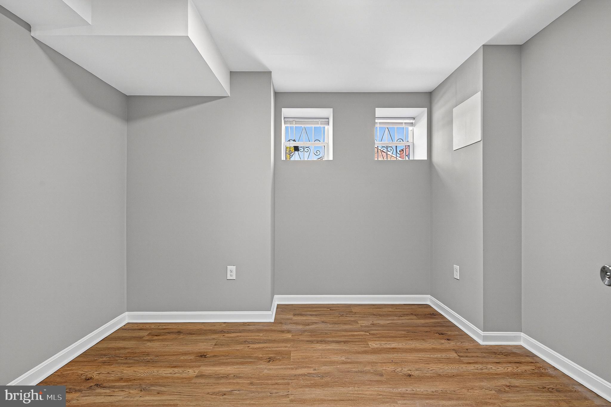 2001 North Fulton Avenue Baltimore, MD 21217 - Photo 26 of 28 a view of an empty room with wooden floor and a window