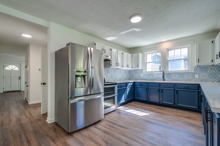 508 Dupont Avenue Madison, TN 37115 - Photo 8 of 22 a kitchen with stainless steel appliances granite countertop a refrigerator a sink dishwasher a stove with wooden floors