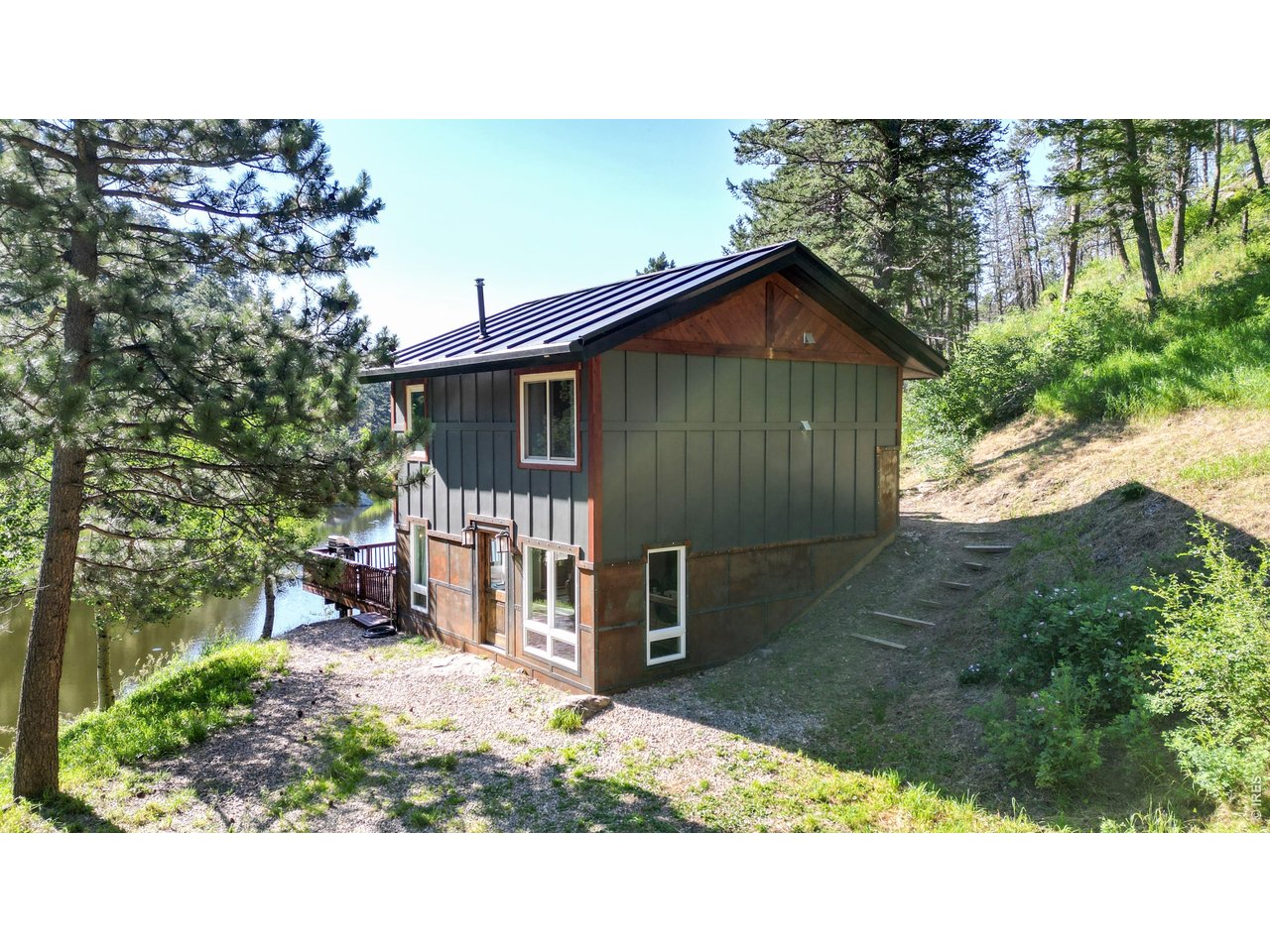 1268 Spring Valley Road Bellvue, CO 80512 - Photo 6 of 33 a backyard of a house with lots of green space