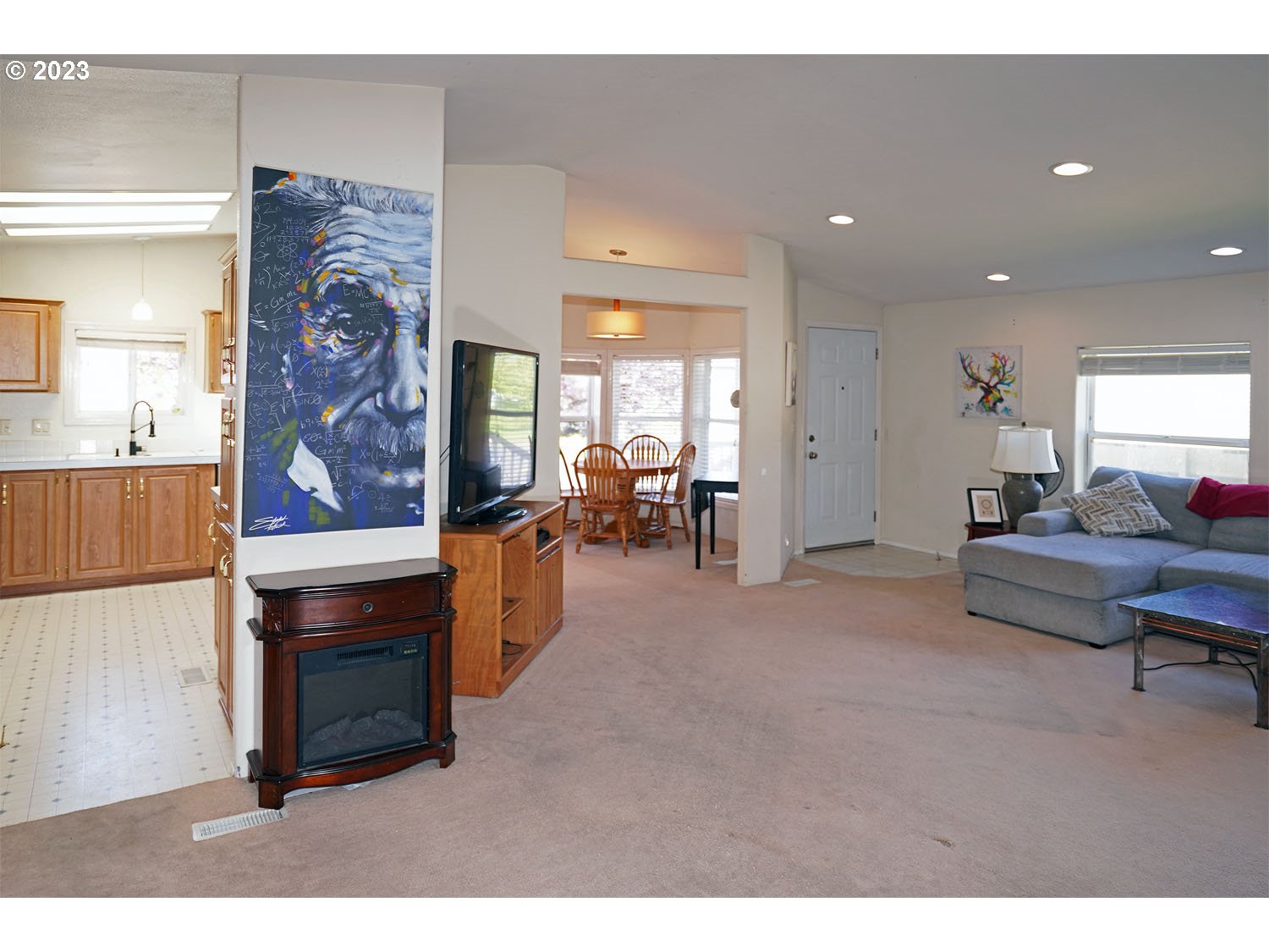 23077 Southwest Main Street, Unit 50 Sherwood, OR 97140 - Photo 13 of 24 a living room with furniture a dining table and kitchen view