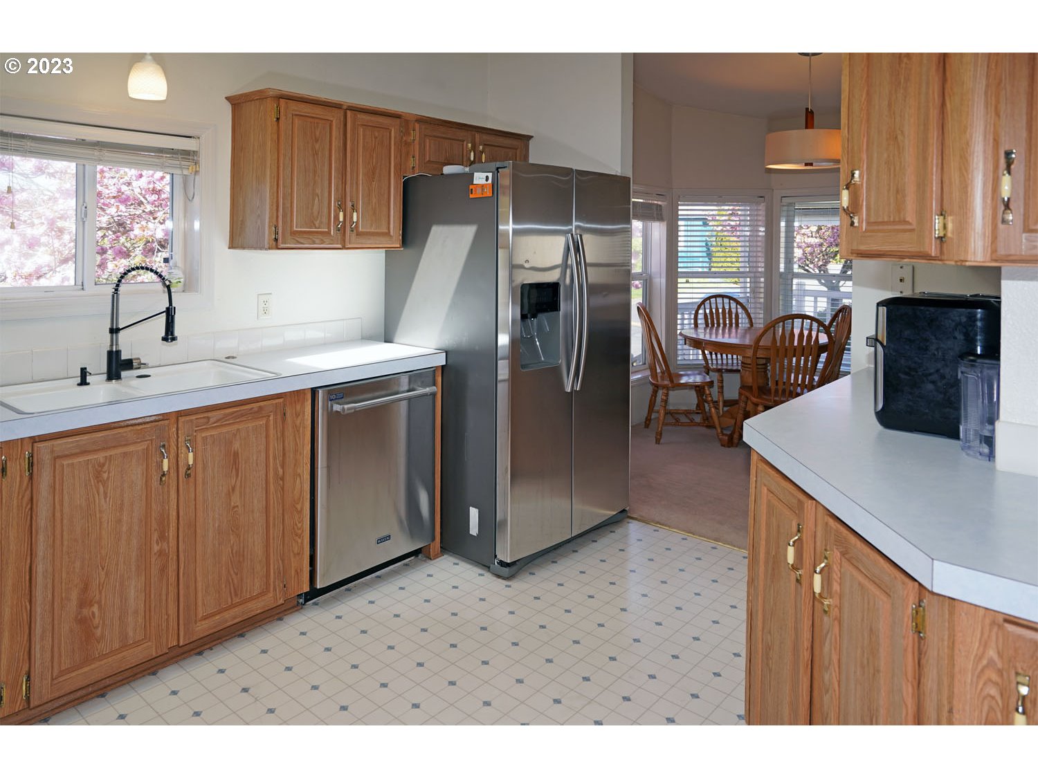 23077 Southwest Main Street, Unit 50 Sherwood, OR 97140 - Photo 17 of 24 a kitchen with a sink refrigerator and cabinets