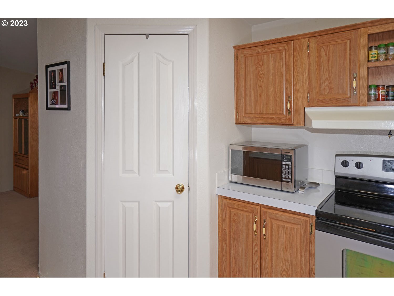 23077 Southwest Main Street, Unit 50 Sherwood, OR 97140 - Photo 18 of 24 a kitchen with stainless steel appliances granite countertop a refrigerator and a stove top oven