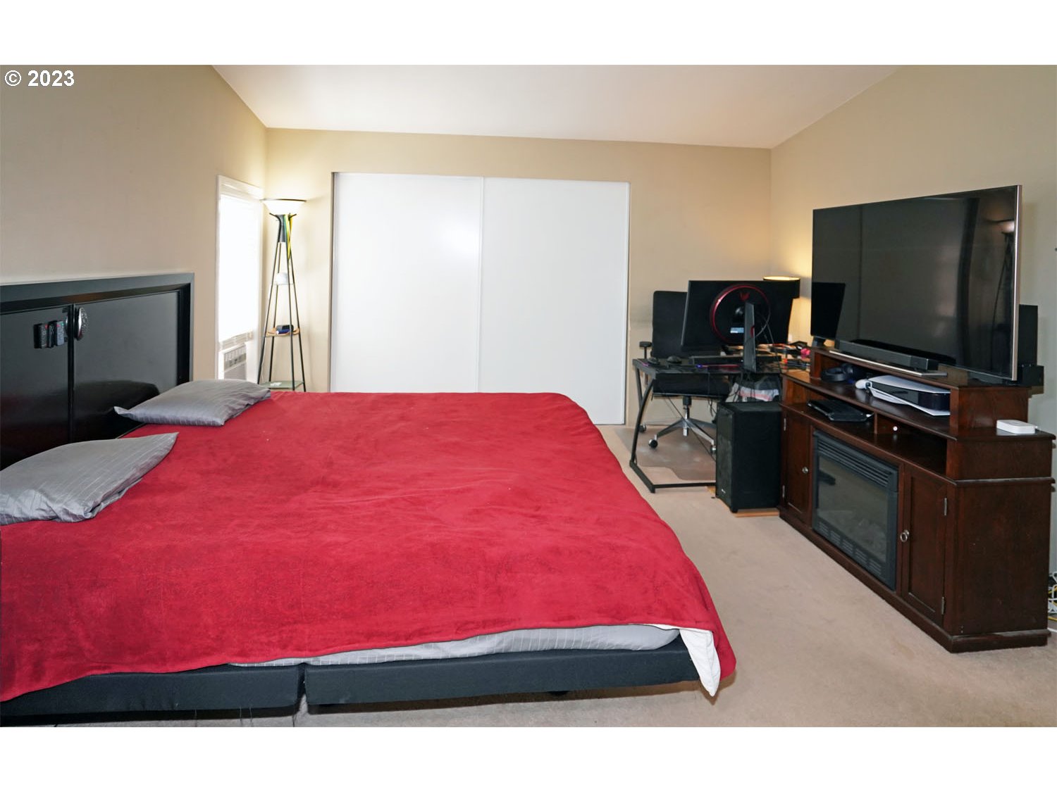 23077 Southwest Main Street, Unit 50 Sherwood, OR 97140 - Photo 20 of 24 a bedroom with a bed and a flat screen tv