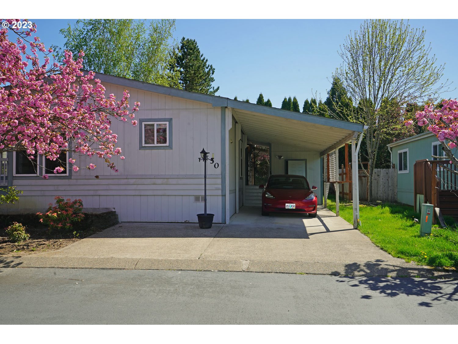 23077 Southwest Main Street, Unit 50 Sherwood, OR 97140 - Photo 2 of 24 a view of a house with backyard porch and sitting area