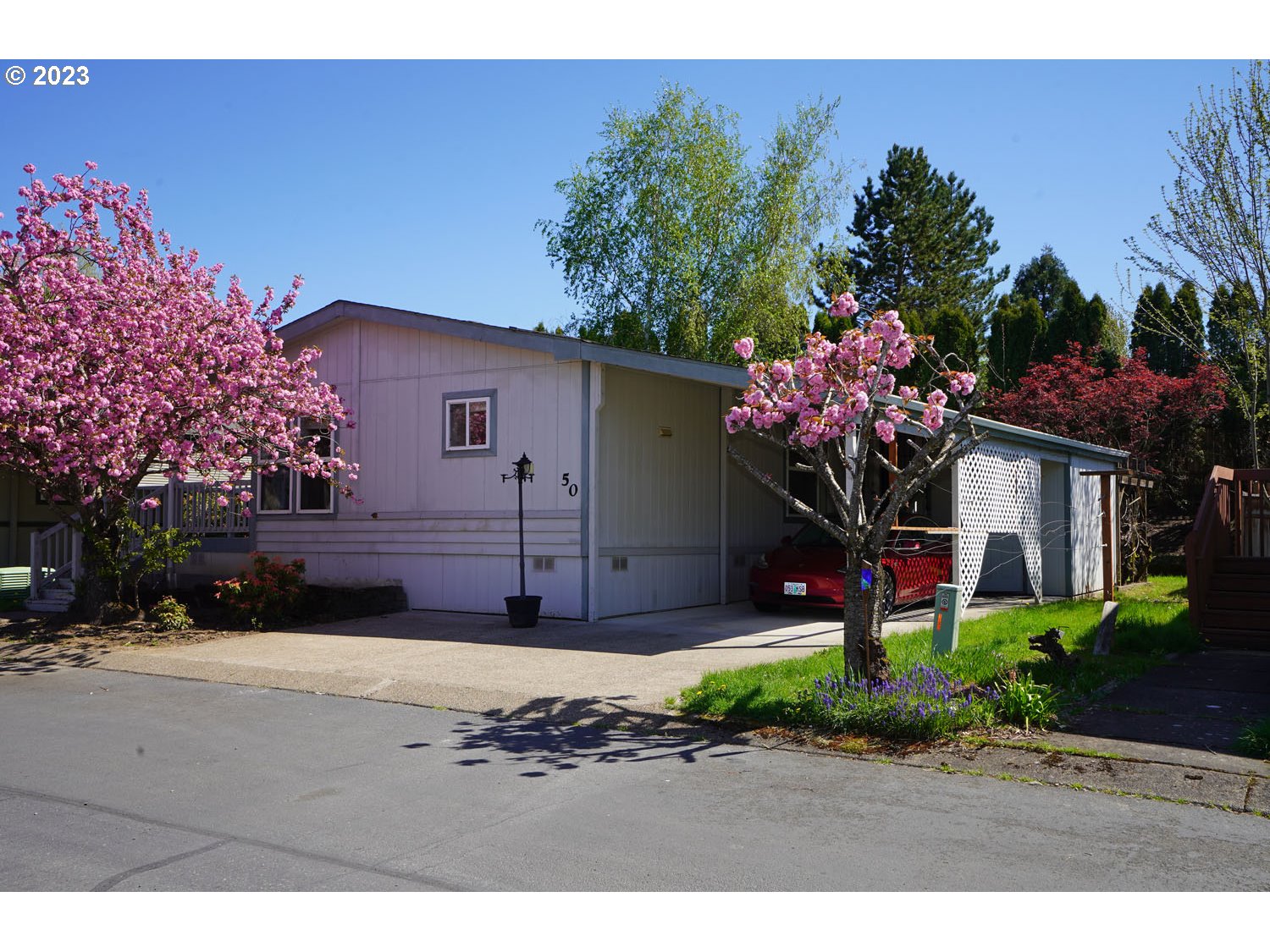 23077 Southwest Main Street, Unit 50 Sherwood, OR 97140 - Photo 3 of 24 a front view of a house with a yard and a garage