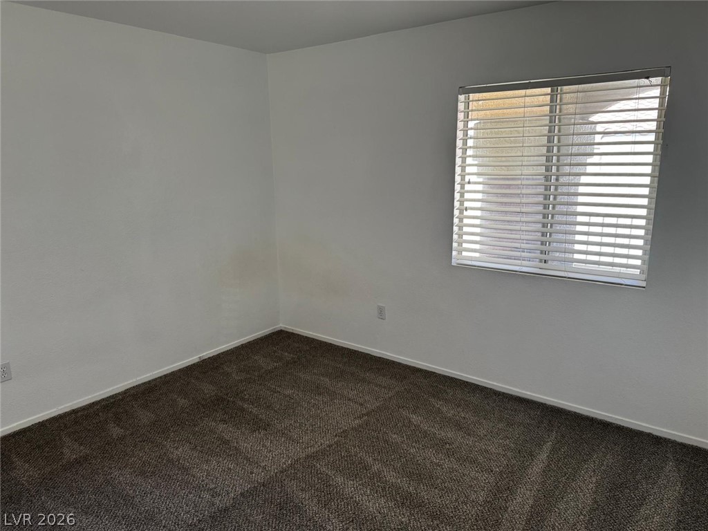 7885 West Flamingo Road, Unit 2171 Las Vegas, NV 89147 - Photo 16 of 22 A well-lit room awaits your personal touch with soft, textured carpet underfoot.