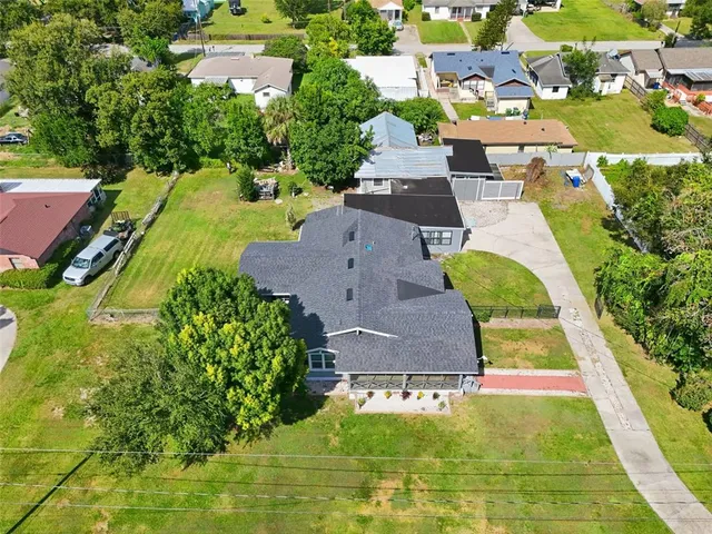 an aerial view of residential houses with yard