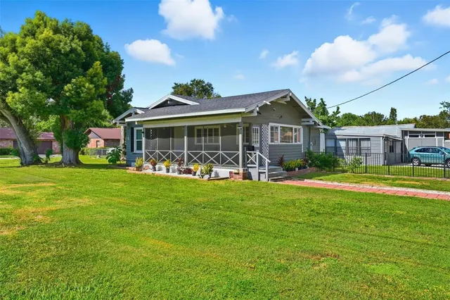 a bedroom with a bed a couch and a flat screen tv