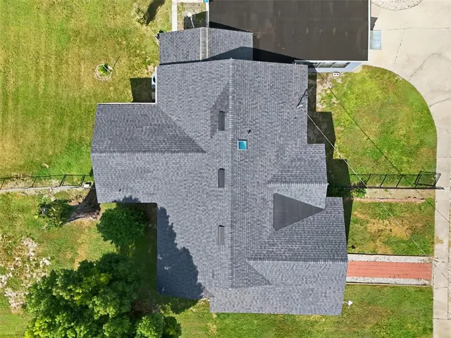 a bedroom with a large bed and a flat tv screen on dresser