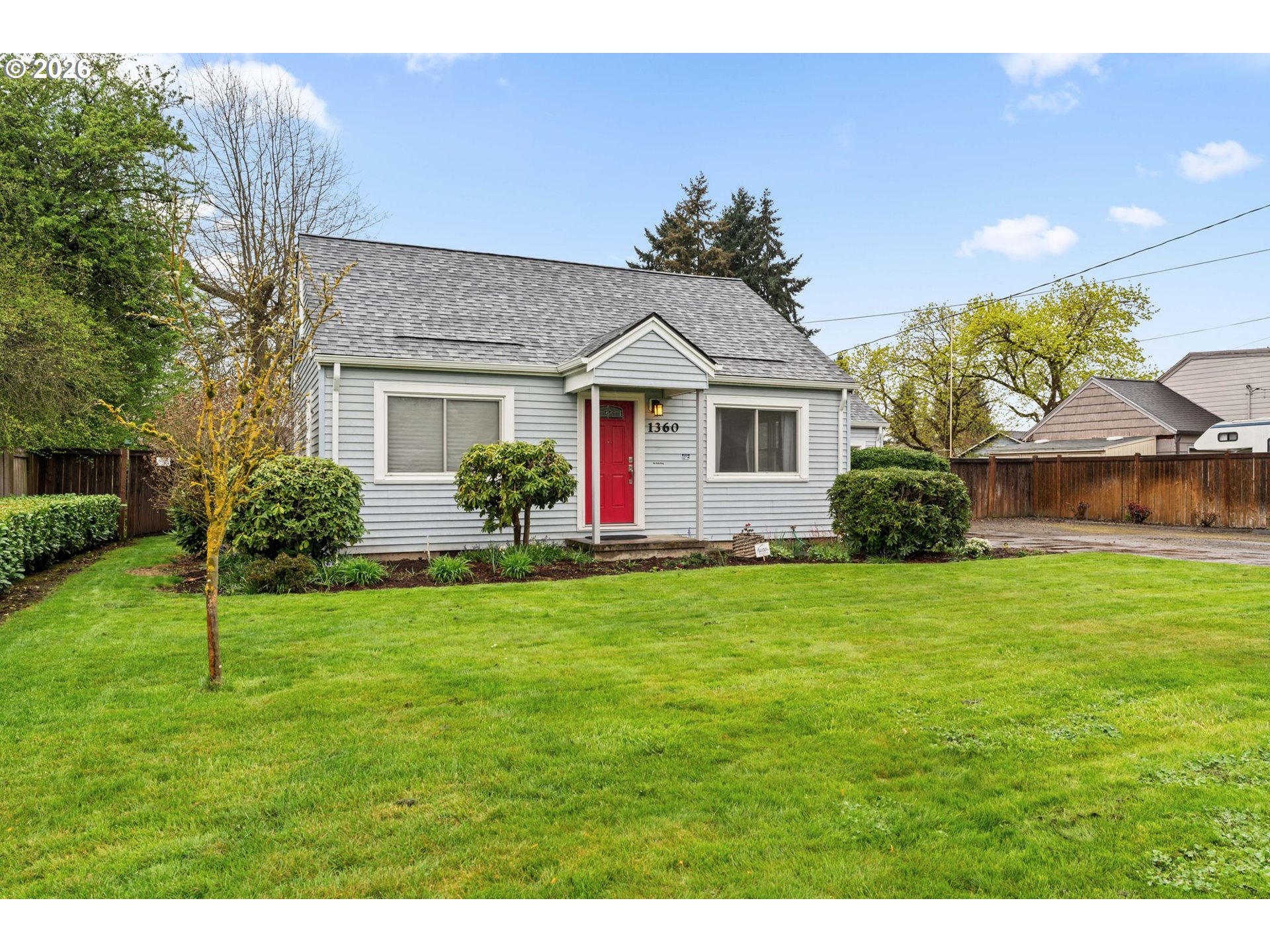 a front view of a house with a garden