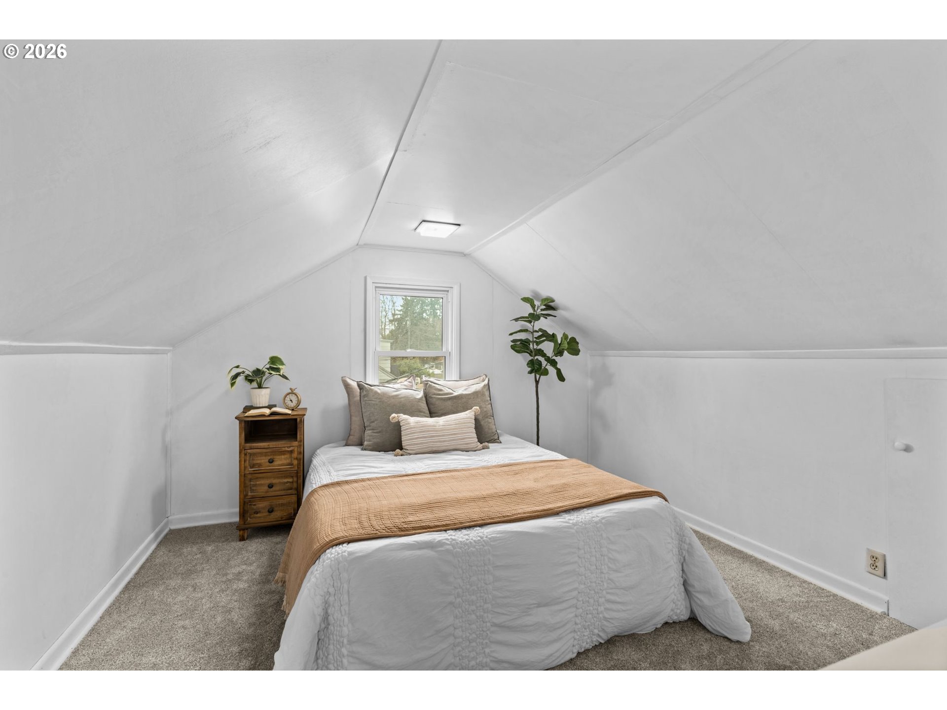 1360 Taft Street Eugene, OR 97402 - Photo 22 of 35 a bedroom with a bed and a potted plant