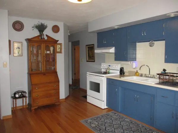 a kitchen with a sink and a stove top oven
