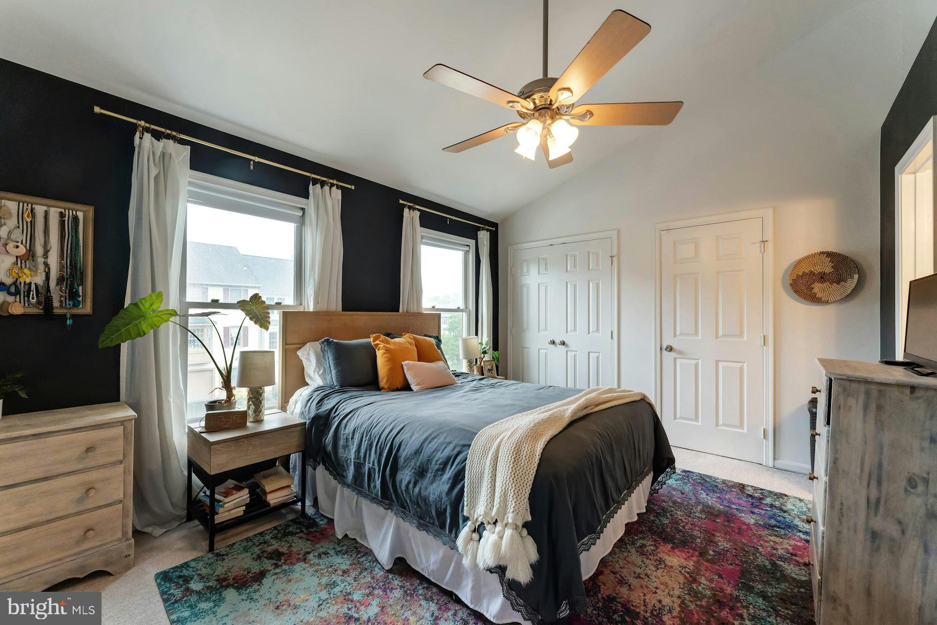 43602 Blacksmith Square Ashburn, VA 20147 - Photo 14 of 33 a bedroom with a bed a chandelier and dresser