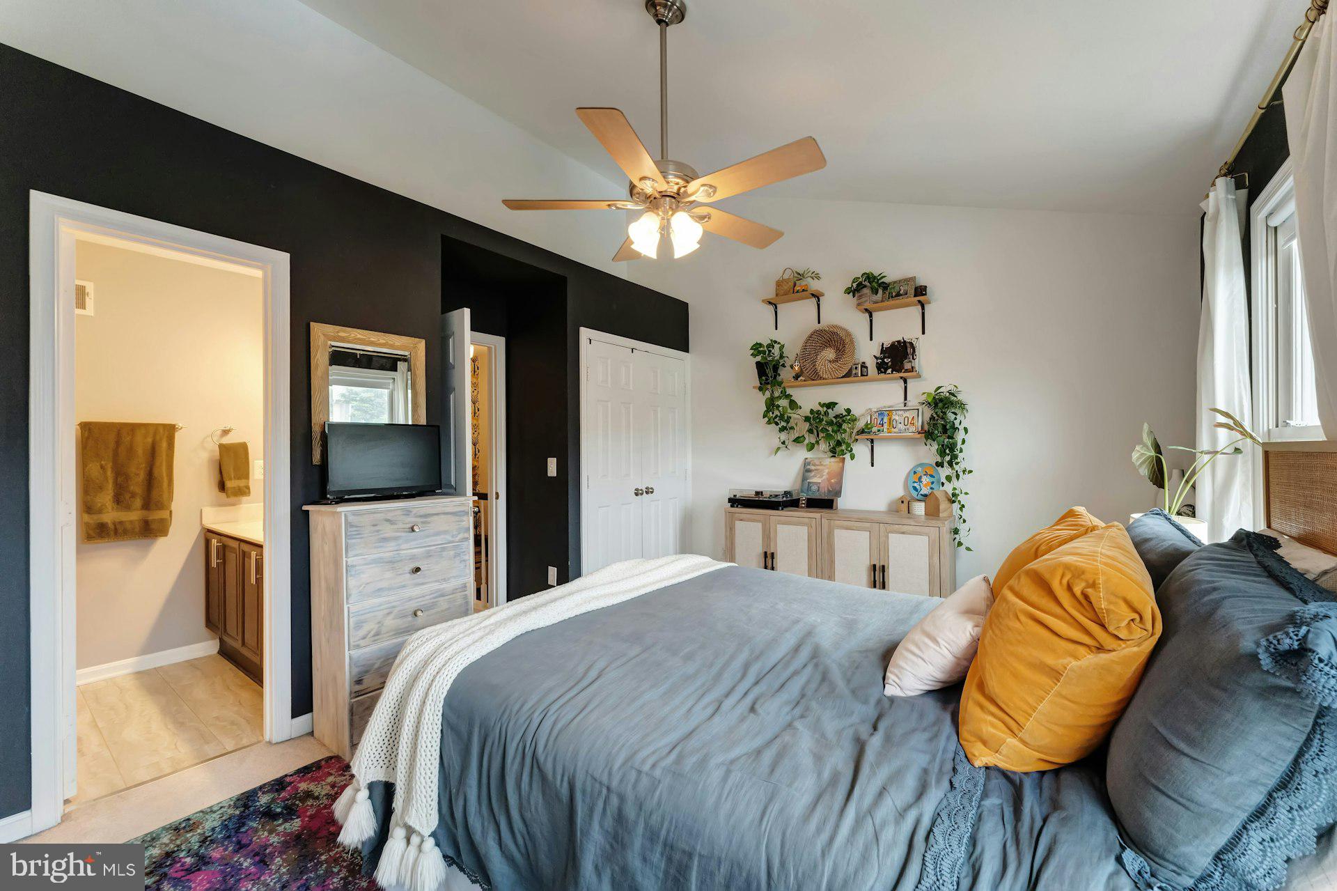 43602 Blacksmith Square Ashburn, VA 20147 - Photo 16 of 33 a bedroom with a bed ceiling fan and a window