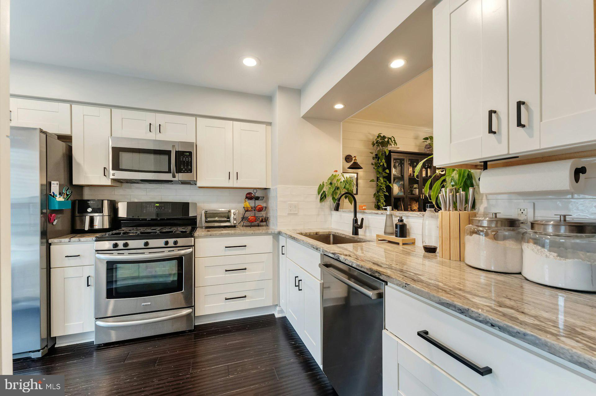 43602 Blacksmith Square Ashburn, VA 20147 - Photo 2 of 33 a kitchen with sink a stove and cabinets
