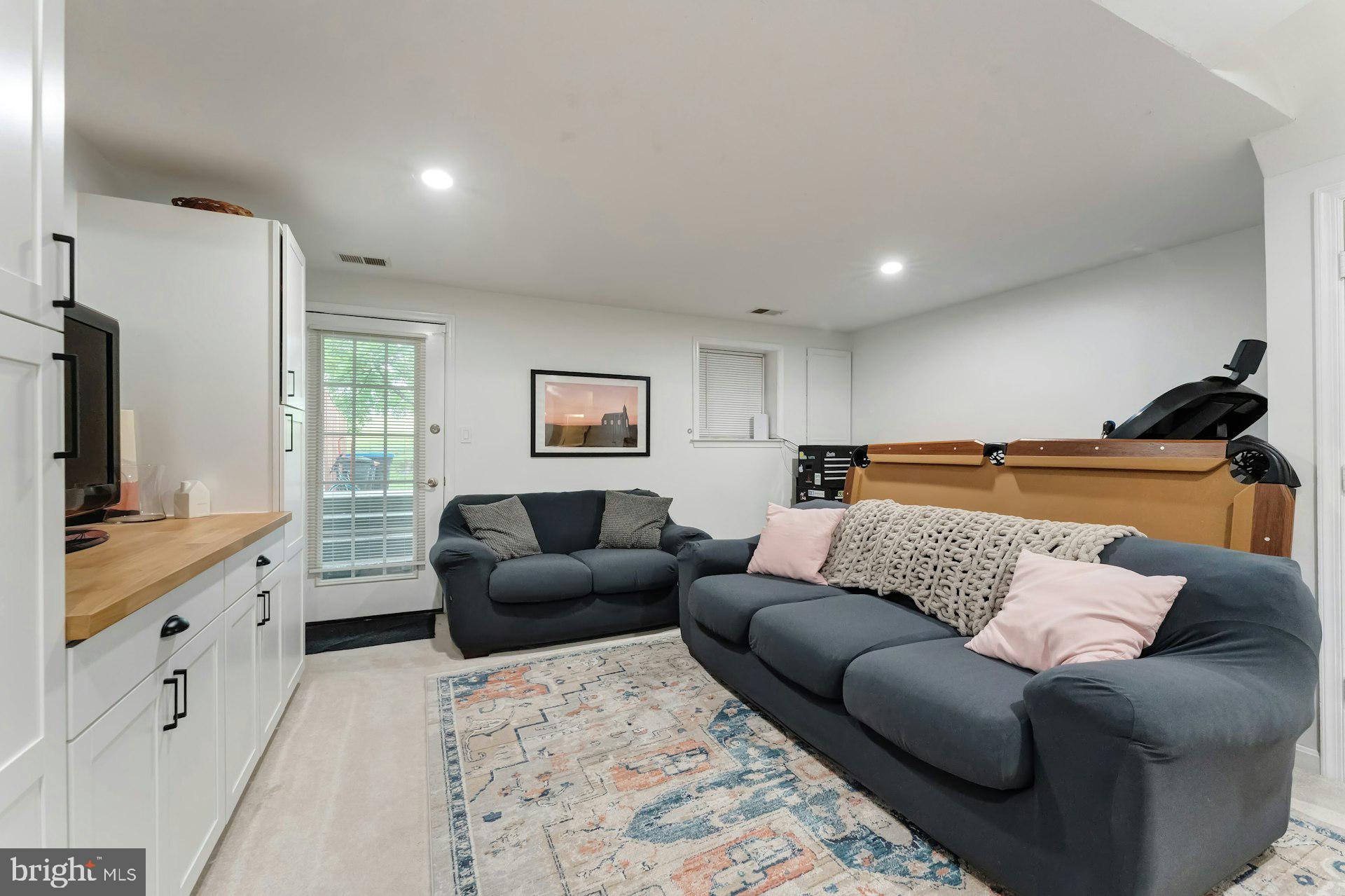 43602 Blacksmith Square Ashburn, VA 20147 - Photo 24 of 33 a living room with furniture and a flat screen tv