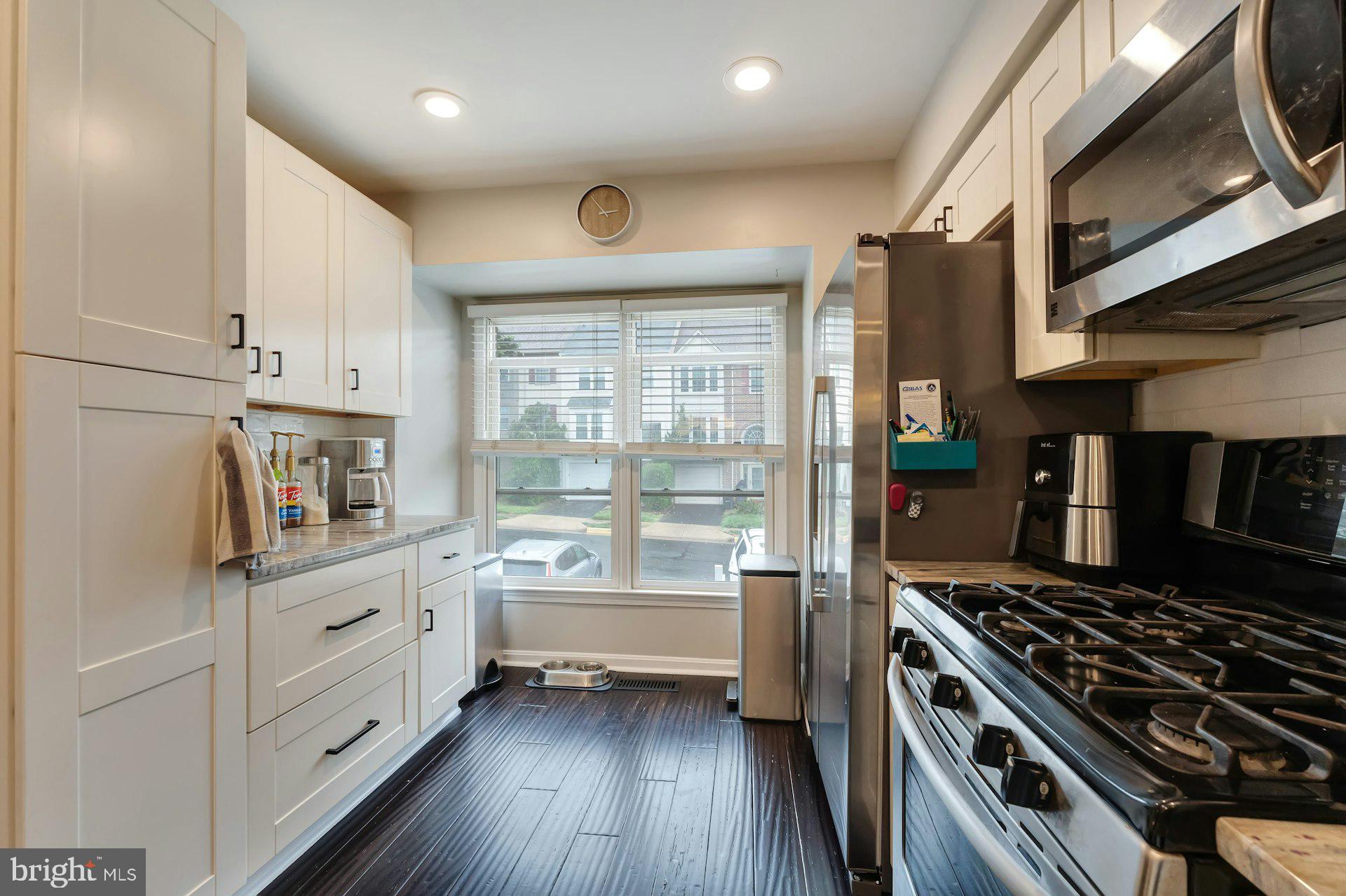 43602 Blacksmith Square Ashburn, VA 20147 - Photo 4 of 33 a kitchen with white cabinets and appliances