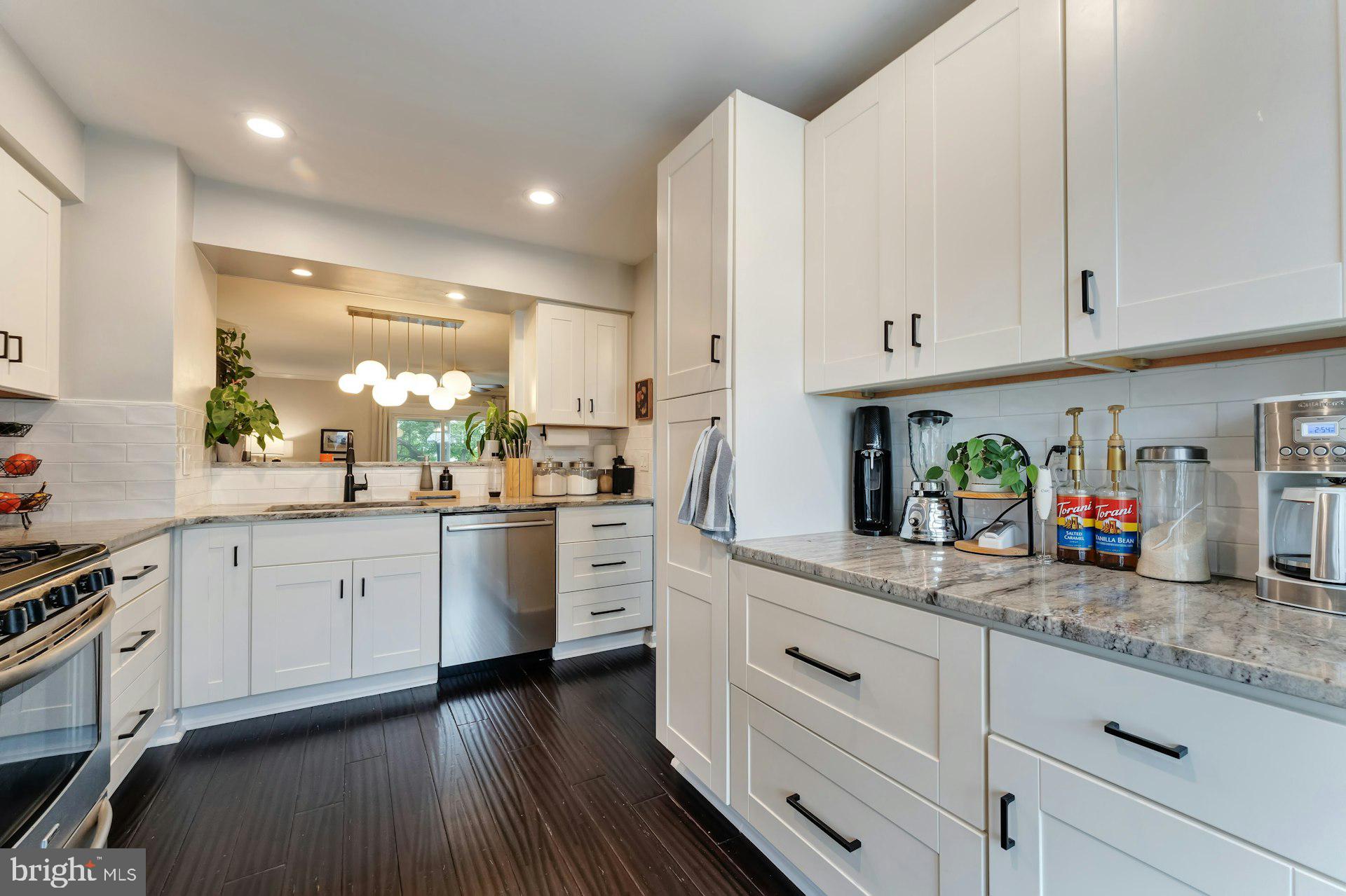 43602 Blacksmith Square Ashburn, VA 20147 - Photo 5 of 33 a kitchen with granite countertop white cabinets and white appliances