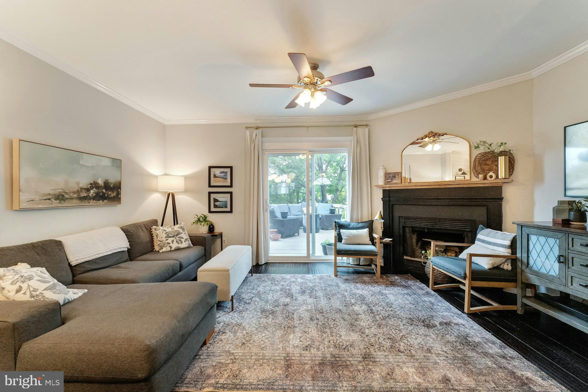 43602 Blacksmith Square Ashburn, VA 20147 - Photo 8 of 33 a living room with furniture a fireplace and a chandelier