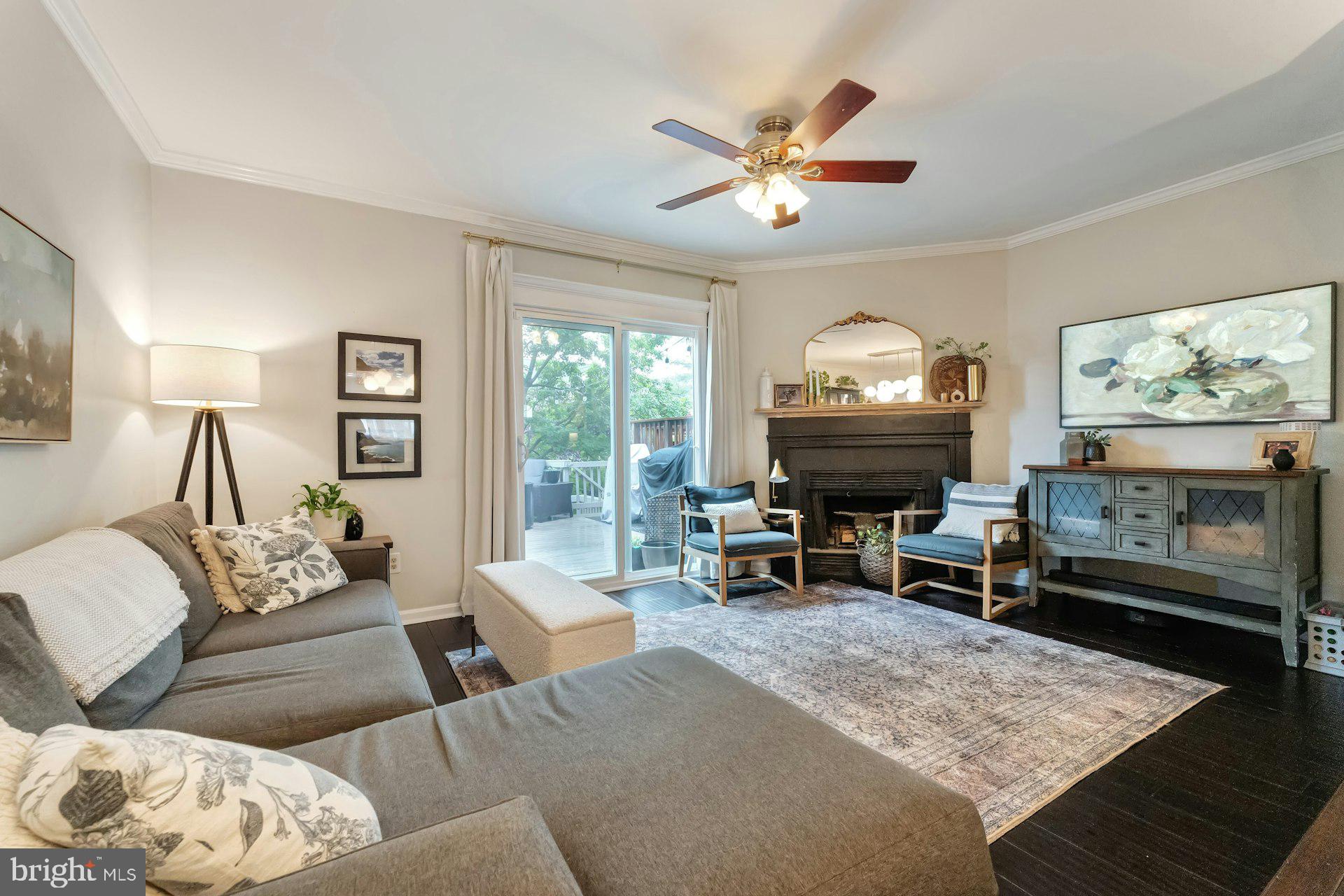 43602 Blacksmith Square Ashburn, VA 20147 - Photo 9 of 33 a living room with furniture a fireplace a large window and a flat screen tv