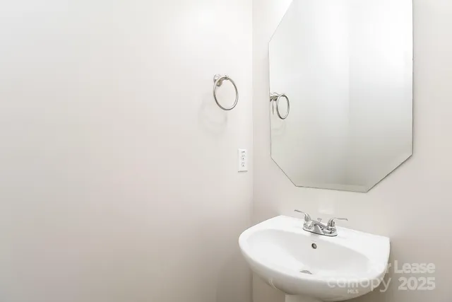 a bathroom with a sink and mirror