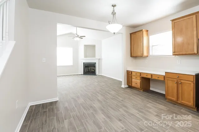 a view of kitchen with granite countertop cabinets and wooden floor