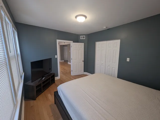 a bedroom with a bed and a flat screen tv