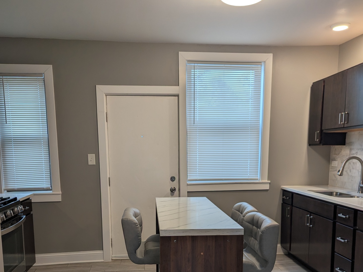 11005 South Perry Avenue, Unit 2 Chicago, IL 60628 - Photo 3 of 17 a bathroom with a sink and a mirror