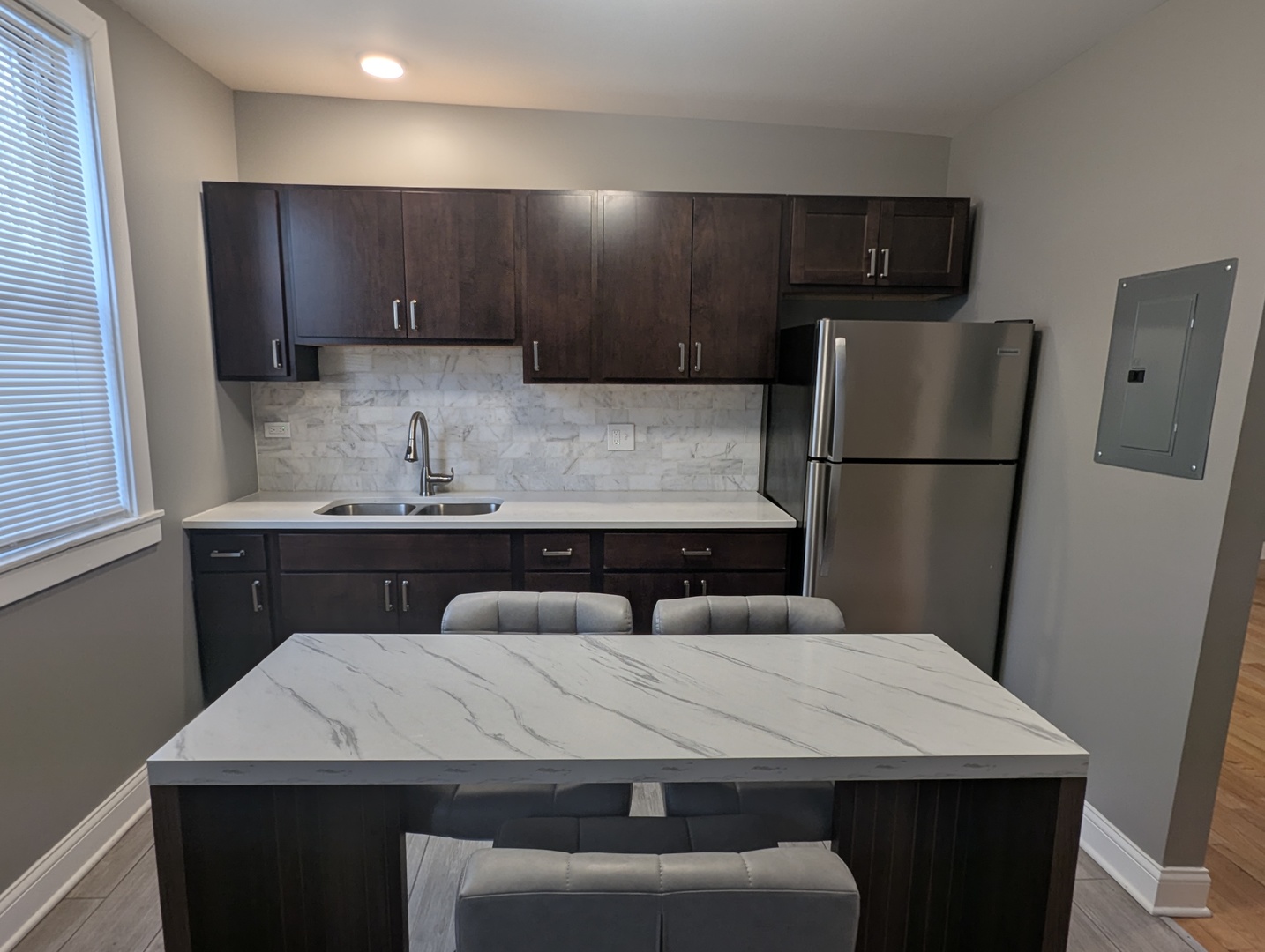 11005 South Perry Avenue, Unit 2 Chicago, IL 60628 - Photo 4 of 17 a kitchen with a sink a refrigerator and wooden cabinets