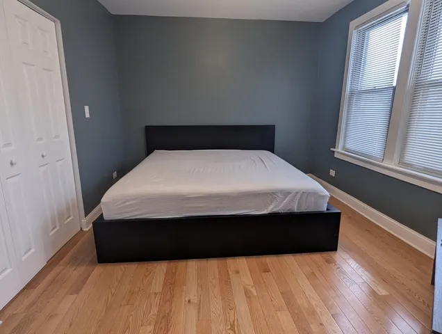a bed sitting in a bedroom next to a window