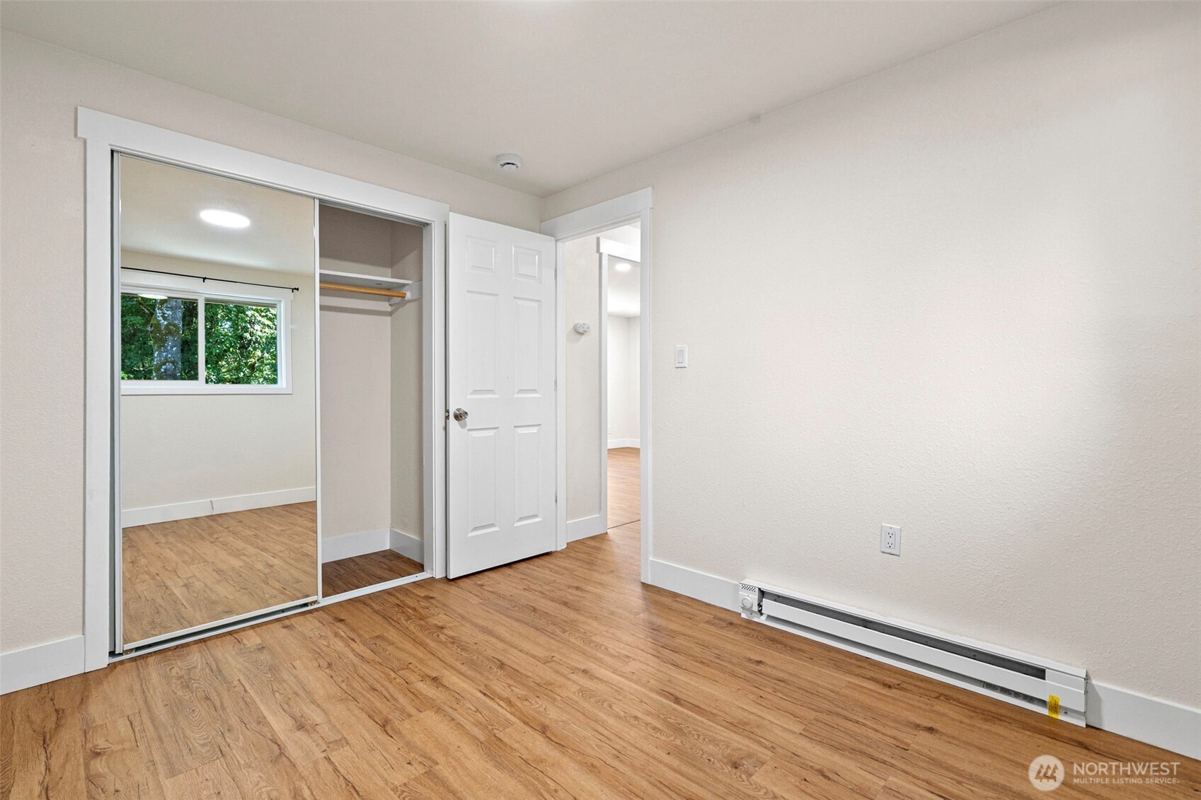 8502-8508 Berkeley Avenue Southwest Lakewood, WA 98498 - Photo 13 of 19 an empty room with wooden floor and windows