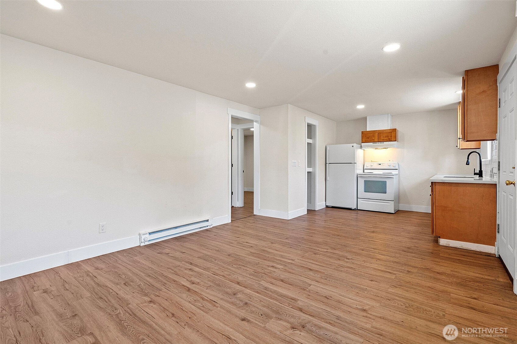 8502-8508 Berkeley Avenue Southwest Lakewood, WA 98498 - Photo 7 of 19 a view of a kitchen with wooden floor and a refrigerator