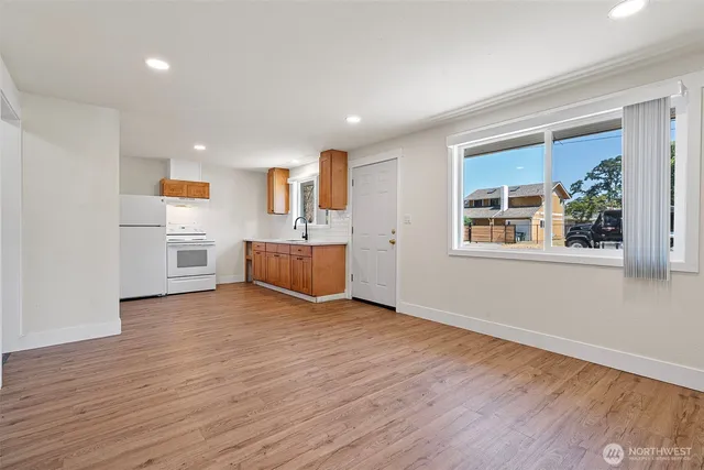a view of a kitchen with a sink a refrigerator and window