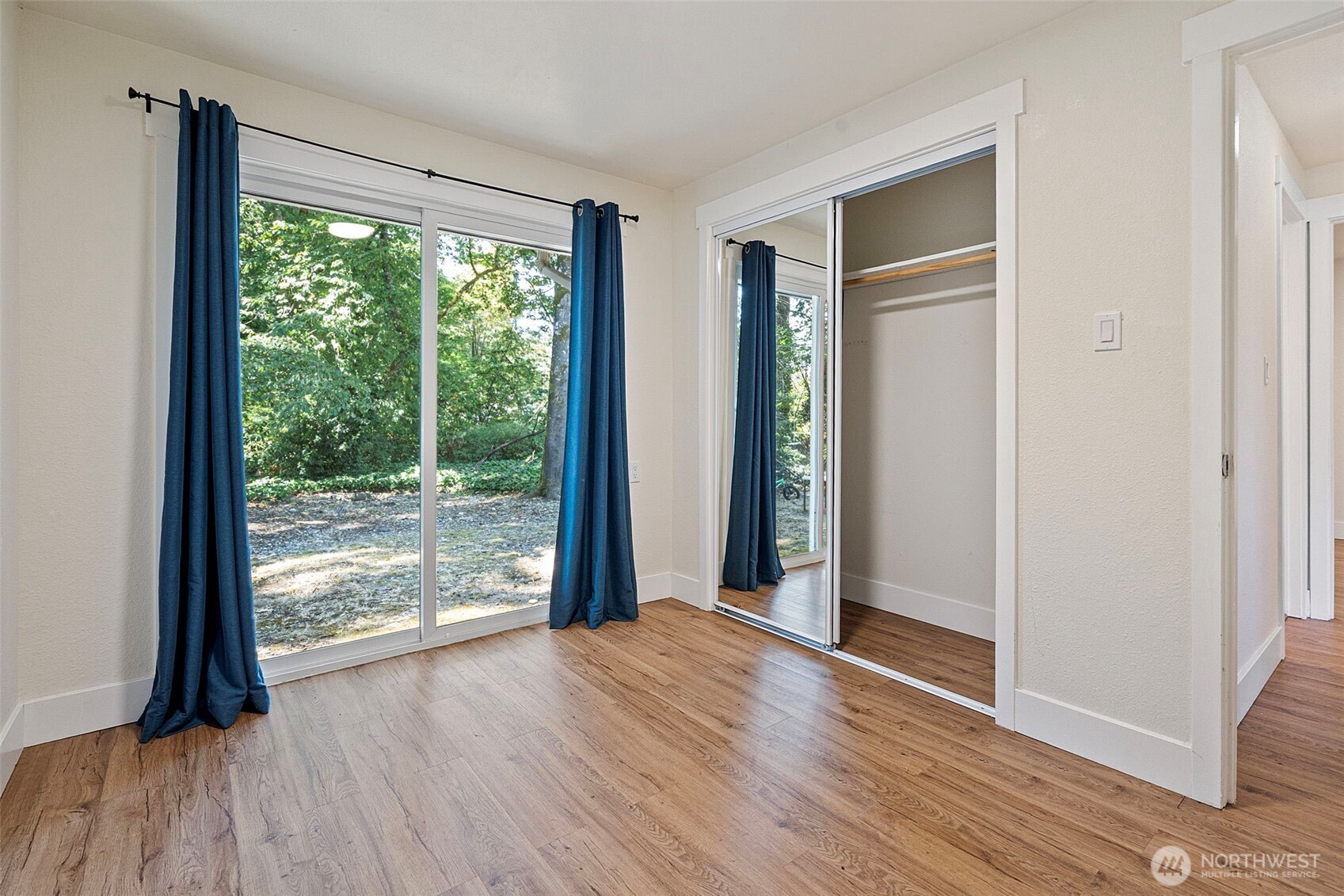 8502-8508 Berkeley Avenue Southwest Lakewood, WA 98498 - Photo 10 of 19 a view of a room with wooden floor and doors