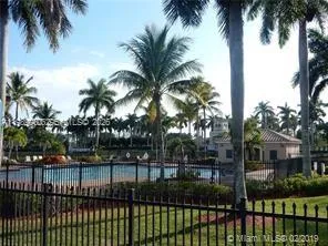 a view of a yard and palm trees