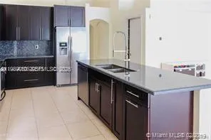 a kitchen with stainless steel appliances a sink stove and refrigerator