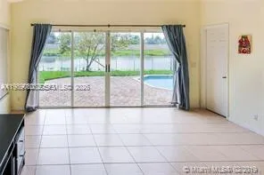 a view of an empty room with a floor to ceiling window and an outdoor space