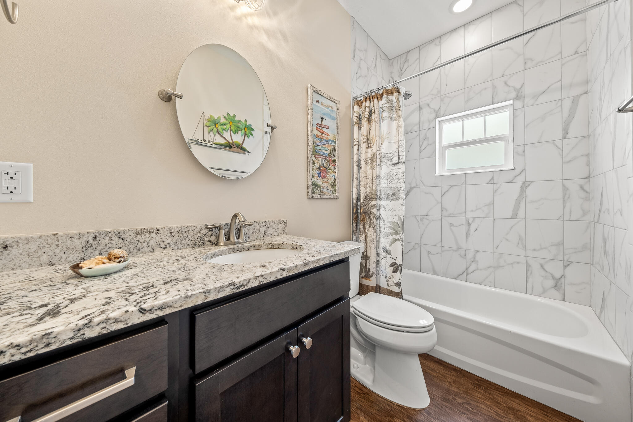 1718 Tullagee Avenue Melbourne, FL 32940 - Photo 21 of 35 a bathroom with a granite countertop toilet a sink and a mirror