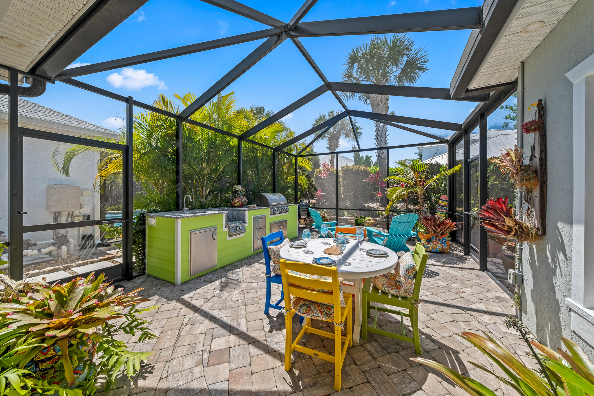 1718 Tullagee Avenue Melbourne, FL 32940 - Photo 25 of 35 a view of a patio with a dining table and chairs