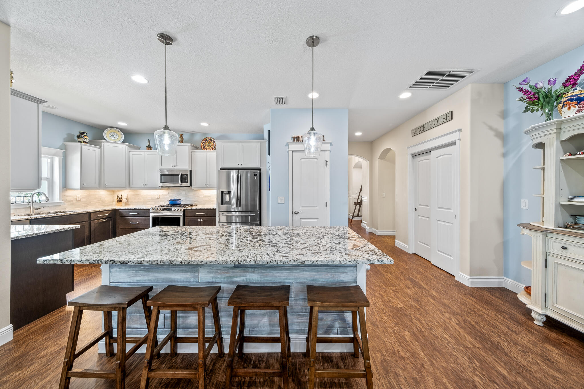 1718 Tullagee Avenue Melbourne, FL 32940 - Photo 6 of 35 a kitchen with granite countertop a table chairs stainless steel appliances and cabinets